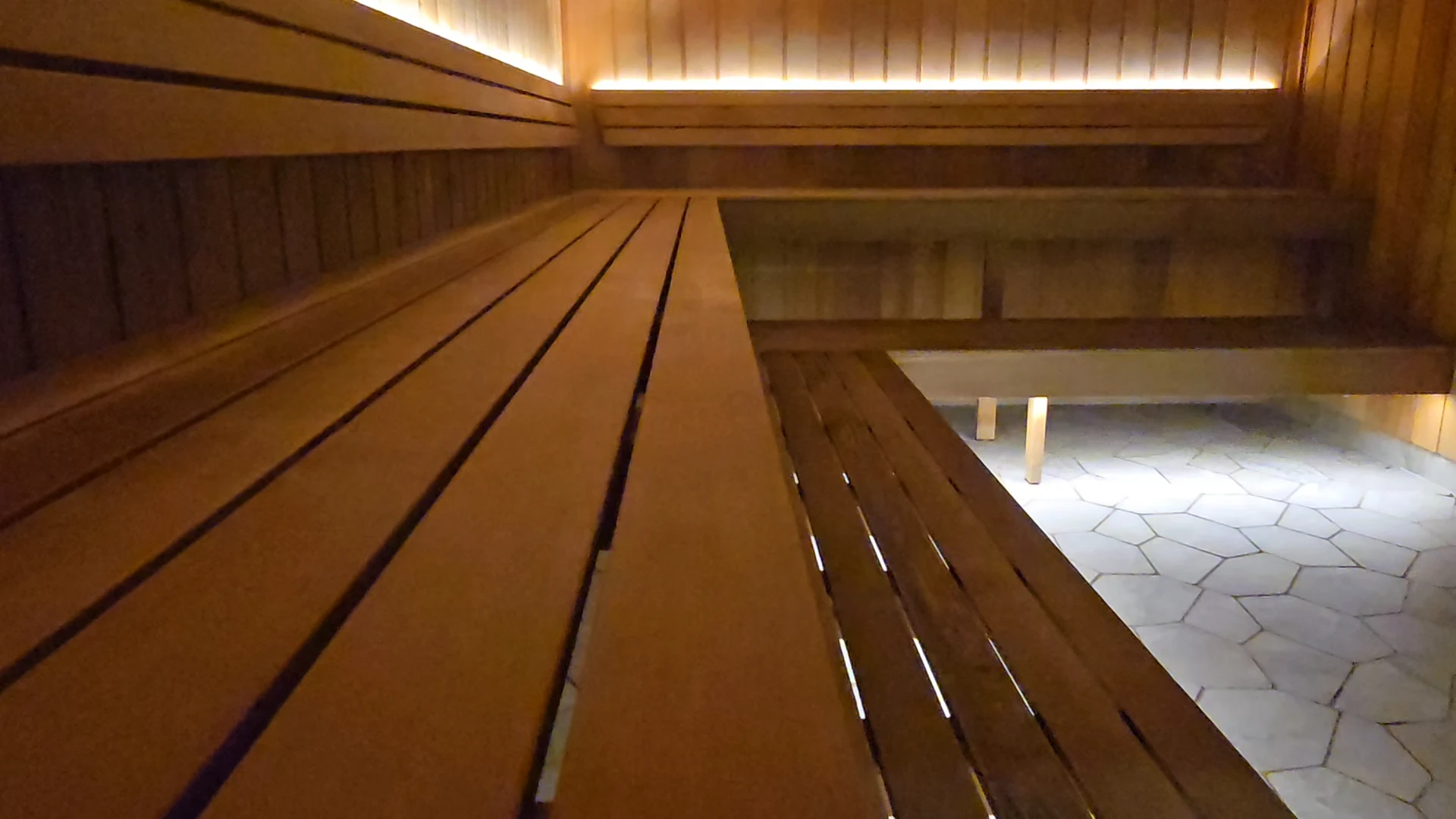 The recovery floor, room by room: the cedar sauna, the magnesium recovery pools lit red and blue, the snow room, a row of massage chairs, and leather recliners beside a wall of compression boots.
